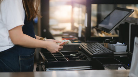 Cropped shot of young asian woman working in small business and recive money from customers