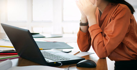 Young asian businesswoman cover her crying face with her hands while she working and recive bad news...