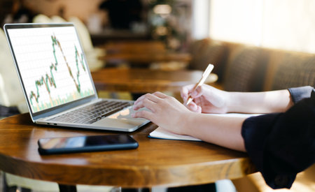 Focus on hand young asian businesswoman using computer laptop work in cafe