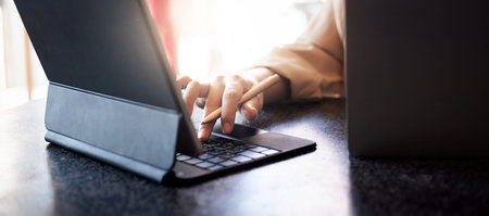 Cropped shot of hand young asian woman typing on laptop computer, concept working home startup...