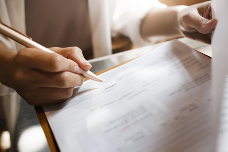 Focus at pen on female hand sign business contract to make sale purchase deal, write signature on document employment agreement, signing insurance  service or legal documentsの写真素材