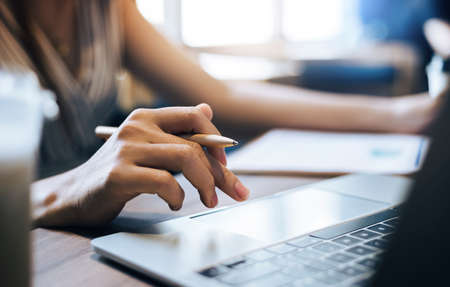 Close up view, young asian woman using laptop computer to working or meeting online with her business group, During a day feman relaxing and use her laptop shopping onlineの写真素材