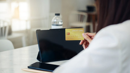 Close up female hands holding credit card, young asian woman paying online, using banking service...