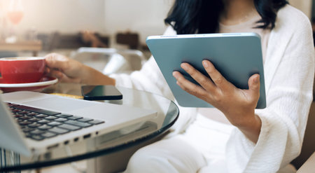 Close up view. young asian woman in casual cloth using tablet computer for entertainment, shopping...