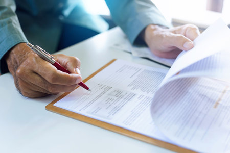 Professional asian businessman or lawer hands holding pen, signing in contract form to confirm and...
