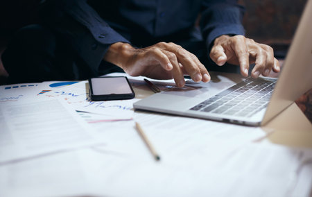Hand of businessman using laptop work and meeting online a thome with business group to planning...