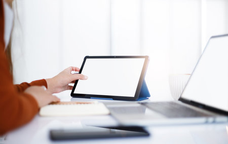 Asian teenage woman study online class at home or cafe by using tablet and laptop, video call with teacher and friends learning, university student studying online conceptの写真素材