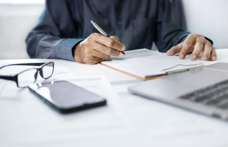 Close-up view, asian businessman reviewing before sign document reports at office workplace. legal...