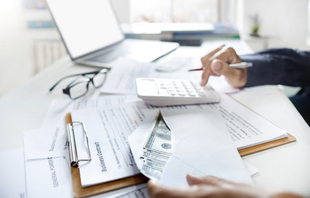 Close-up view, dollar in envelope with business contract documents. businessman success to start new business and calculating income or commission when start working for the first timeの写真素材