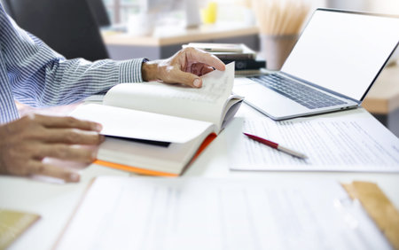 Asian businessman sit at desk working and study online. watch webinar or training course via laptop,...