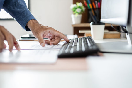 Close-up shot, asian businessman meeting online with business group via desktop PC checking document...