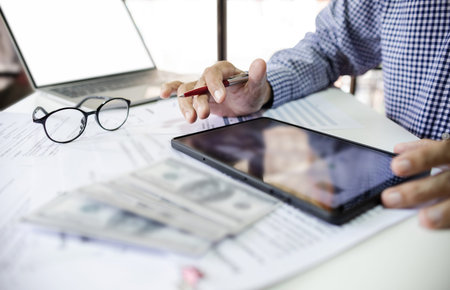 Asian businessman working in office using tablet for online business with business documents....