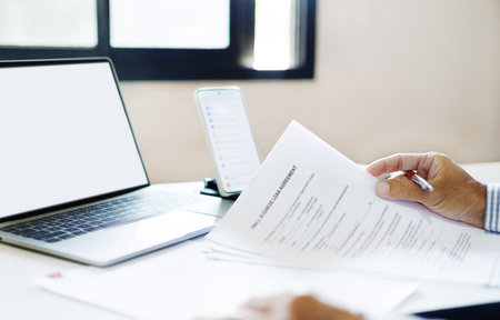 asian businessman holding personal loan agreement documents checking contract details and checking...