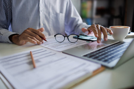 asian businessman checking business contract and using laptop working and meeting online with...