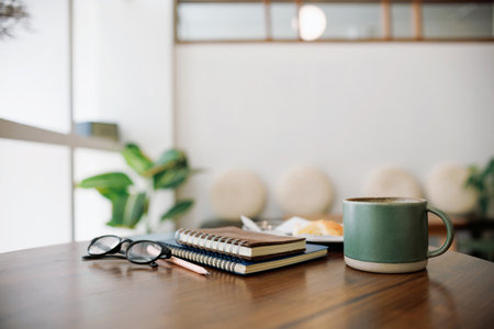 coffee drink and note book, diary for taking note with breakfast on wooden tableの写真素材