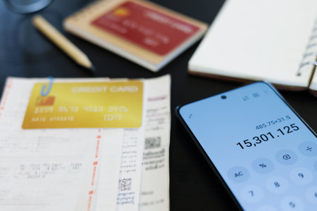 close up shot, mobile screen is showing calculator app and calculate receipt ,bills, expenses from credit card before payの写真素材