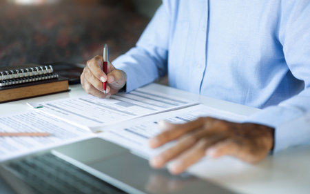 asian businessman, legal expert, professional lawyer working with laptop reviewing document and...