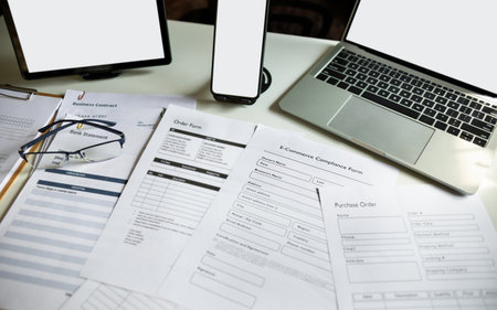 modern communication devices and documents about e-commerce, order form on desk use for online business, e-commerce online business conceptの写真素材
