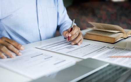 asian businessman, legal expert, professional lawyer working on desk reviewing document and business contract before provide legal advice to clientsの写真素材