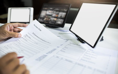 close up shot, asian man start e-commerce business checking document, order form working online with...