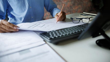 close up shot, accountant working with computer reviewing the company's accounts and financial...