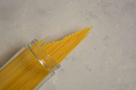 Raw spaghetti wrapped with rope on a black background, close upの写真素材