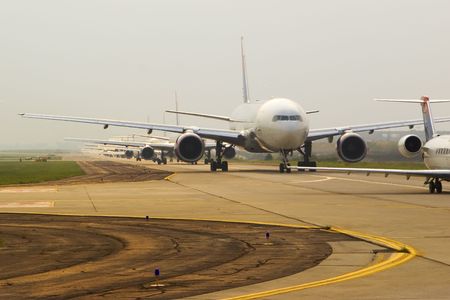 Commercial airplanes in line to take offの写真素材