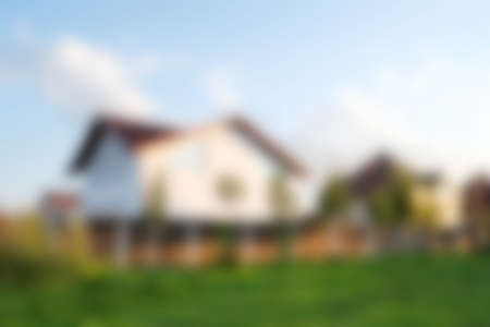 Blurred abstract background of house at the summer. House exterior theme creative abstract blur background with bokeh effect. Blurred house, lawn, poolの写真素材