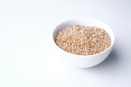 oat seeds in a black plate isolated on white background top view. Copyspaceの写真素材