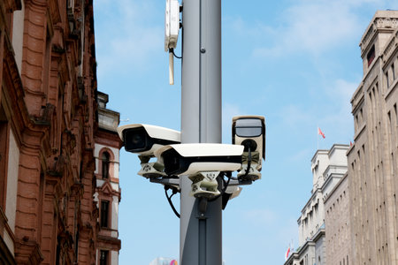 The surveillance camera in Shanghai streets. Monitoring famous tourism travel destination. Skyscrapers in background.の写真素材