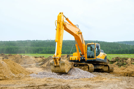 Excavator Digging Trench with Open Manhole at Construction Site