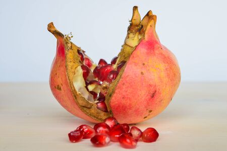 Pomegranate on white cutting boardの写真素材