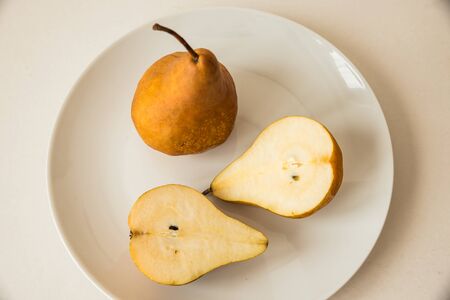 Cut pears on a white plateの写真素材