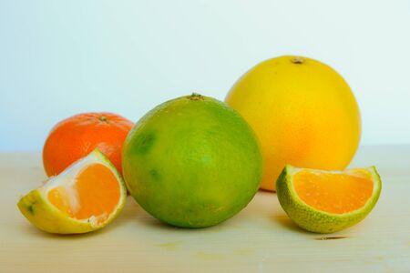 Grapefruit, lemon, ugli, tangerine on a cutting boardの写真素材
