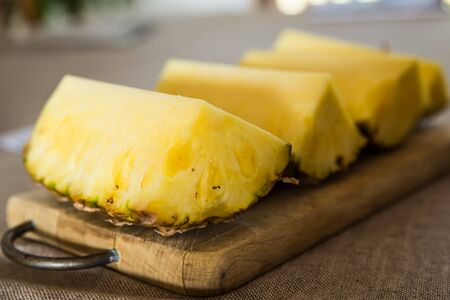 Pineapple slices on a cutting boardの写真素材