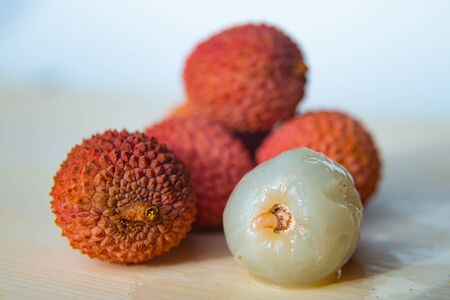 Lychees on a white cutting boardの写真素材