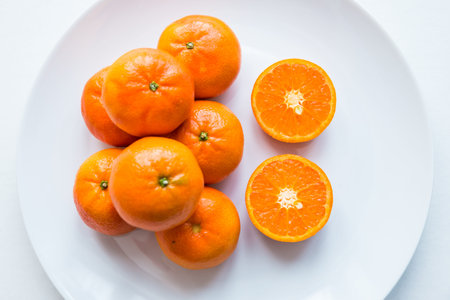 Tangerines on a white plate