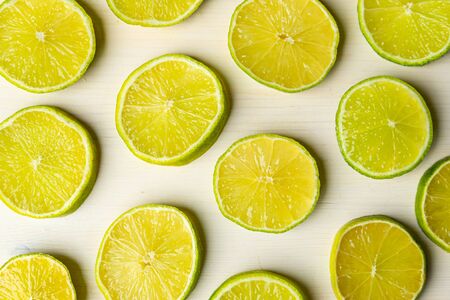 Lime slices on white cutting boardの写真素材