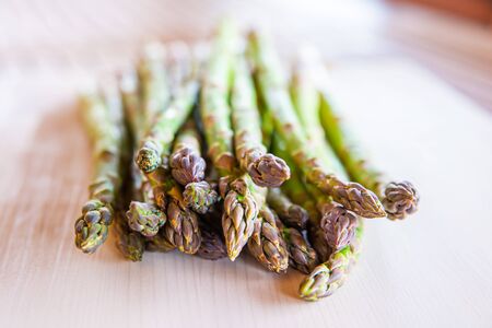 Freshly picked asparagus, on wooden surfaceの写真素材