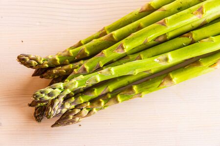 Freshly picked asparagus, on wooden surfaceの写真素材
