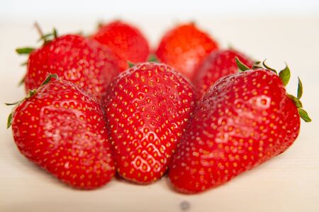 Ripe strawberries on a wooden surfaceの写真素材