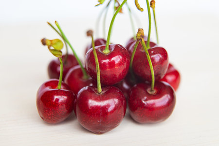 Ripe cherries on a wooden surface