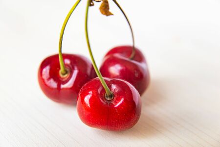 Ripe cherries on a wooden surfaceの写真素材