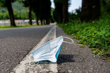 mask thrown on the streetの写真素材