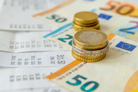 Ordinary living expenses receipts, notes and coins to pay for them; ordinary cost of living.の写真素材