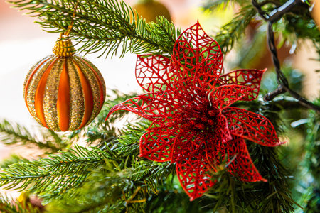 Christmas tree decorations, with fake red balls and flowers.の写真素材