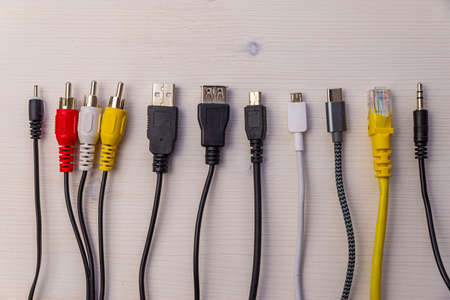 Various types of plugs and cables for audio, video, computer, smartphone and recharging connections. Evolution and change of the types of analog and USB connectors.の写真素材