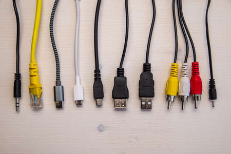 Various types of plugs and cables for audio, video, computer, smartphone and recharging connections. Evolution and change of the types of analog and USB connectors.の写真素材