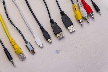Various types of plugs and cables for audio, video, computer, smartphone and recharging connections. Evolution and change of the types of analog and USB connectors.の写真素材