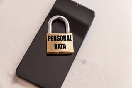 Smartphone with a padlock on it that says "personal data". Data security, which are contained in your electronic devices.の写真素材